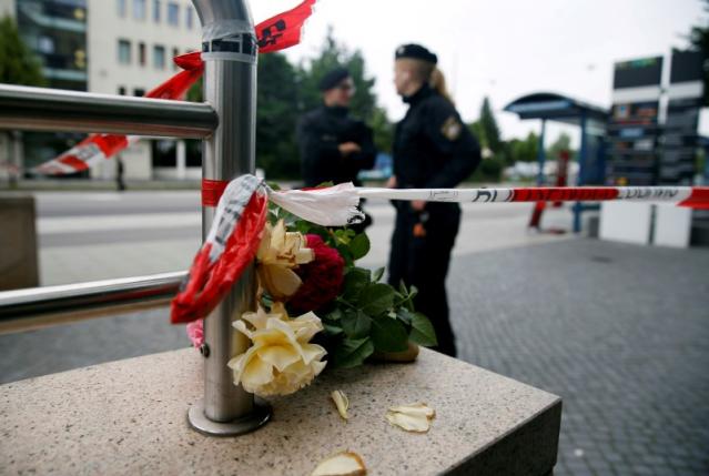 Flowers are placed near the Olympia shopping mall, where yesterday's shooting rampage started, in Munich, Germany, July 23, 2016. REUTERS/Michael Dalder