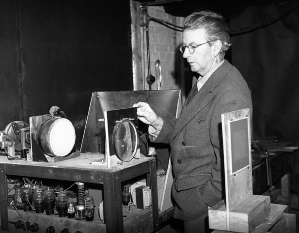 17th December 1942:  Scottish electrical engineer and television pioneer John Logie Baird (1888 - 1946) giving a demonstration in his laboratory of his latest advance in colour television.  Baird was born in Helensburgh and studied at Glasgow University. Baird worked as an engineer at Clyde Valley Electric Power Company but had to retire due to ill health. He used his time to conduct experimental research into the transmission of images and gave a successful public display of his television system in London on 27th January 1926. In 1929 his mechanically scanned system was adopted by the BBC and he provided an improved system five years later. Baird also helped pioneer colour television and stereophonic sound.  (Photo by Topical Press Agency/Getty Images)