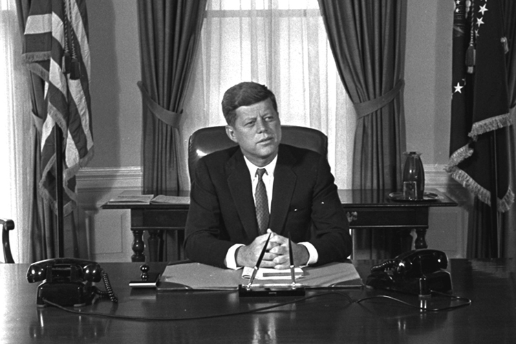 Newly-elected President Kennedy posed for first pictures at his White House desk, January 21, 1961, before plunging into a busy round of conferences. (AP Photo/Bill Achatz)