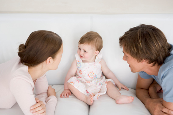 Parents with baby on couch.