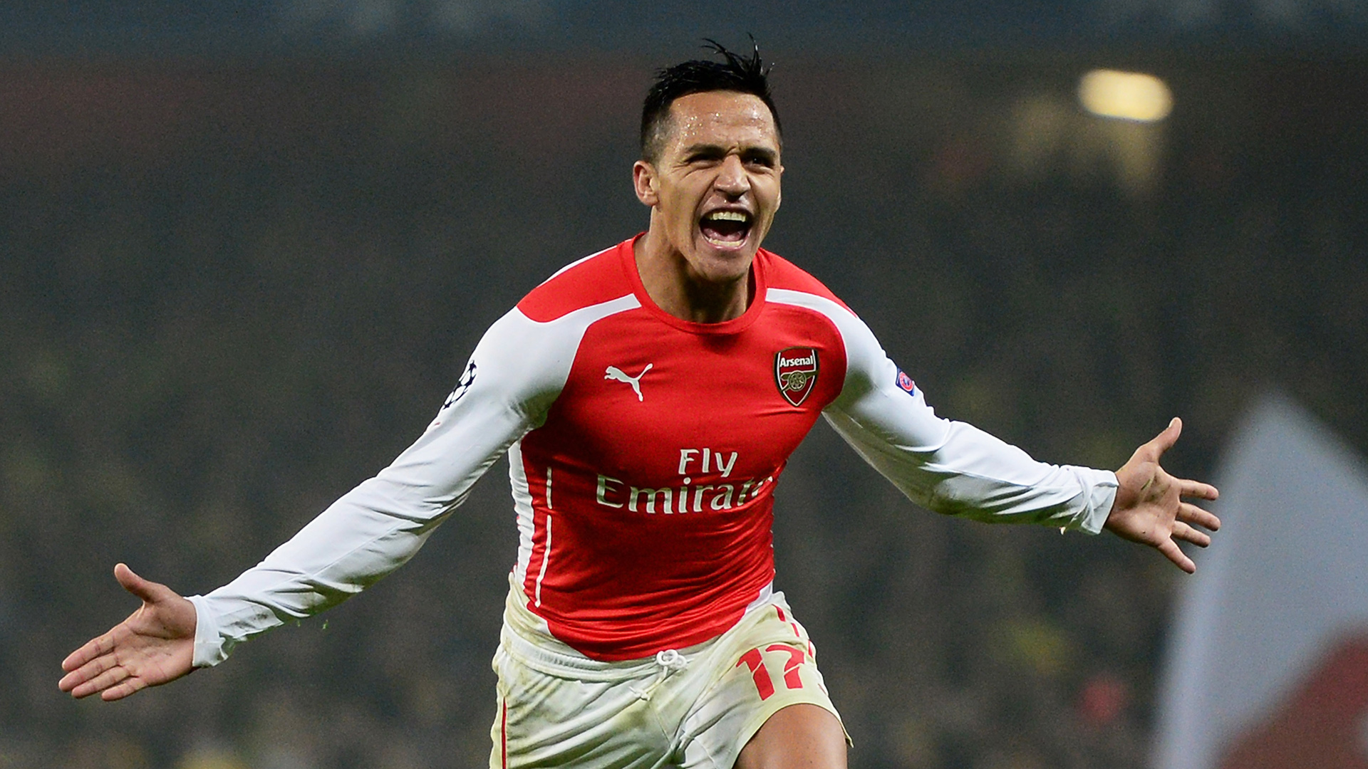 LONDON, ENGLAND - NOVEMBER 26:  Alexis Sanchez of Arsenal celebrates after scoring his team's second goal during the UEFA Champions League Group D match between Arsenal and Borussia Dortmund at the Emirates Stadium on November 26, 2014 in London, United Kingdom.  (Photo by Jamie McDonald/Getty Images)