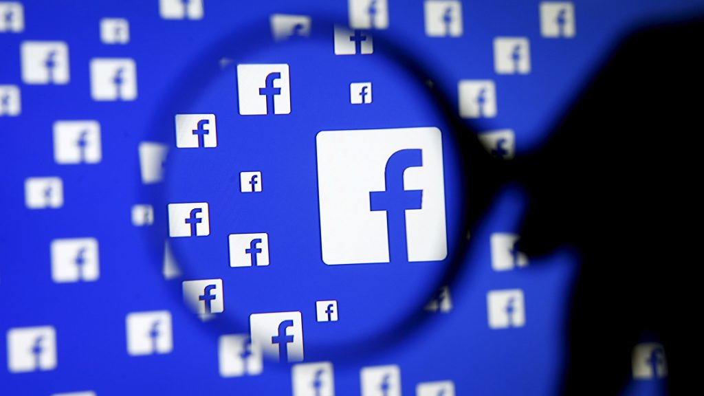 A man poses with a magnifier in front of a Facebook logo on display in this illustration taken in Sarajevo, Bosnia and Herzegovina, December 16, 2015.   REUTERS/Dado Ruvic/Illustration/File Photo   GLOBAL BUSINESS WEEK AHEAD PACKAGE - SEARCH "BUSINESS WEEK AHEAD JULY 25" FOR ALL IMAGES - RTSJGEL