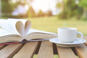 Coffee cup and book on the table in the morning