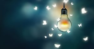 luminous bulb and butterflies flying on light